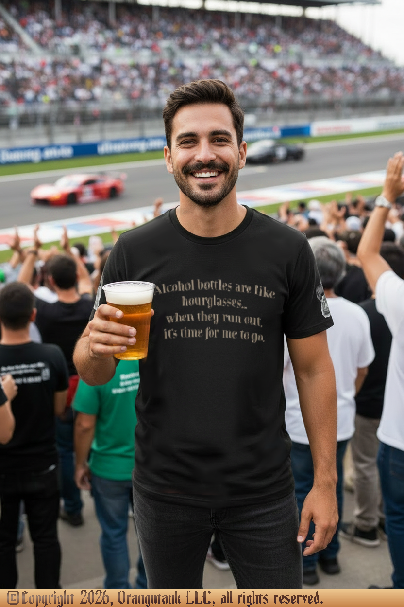 Man holding a beer at a race track event with cars and spectators in the background.